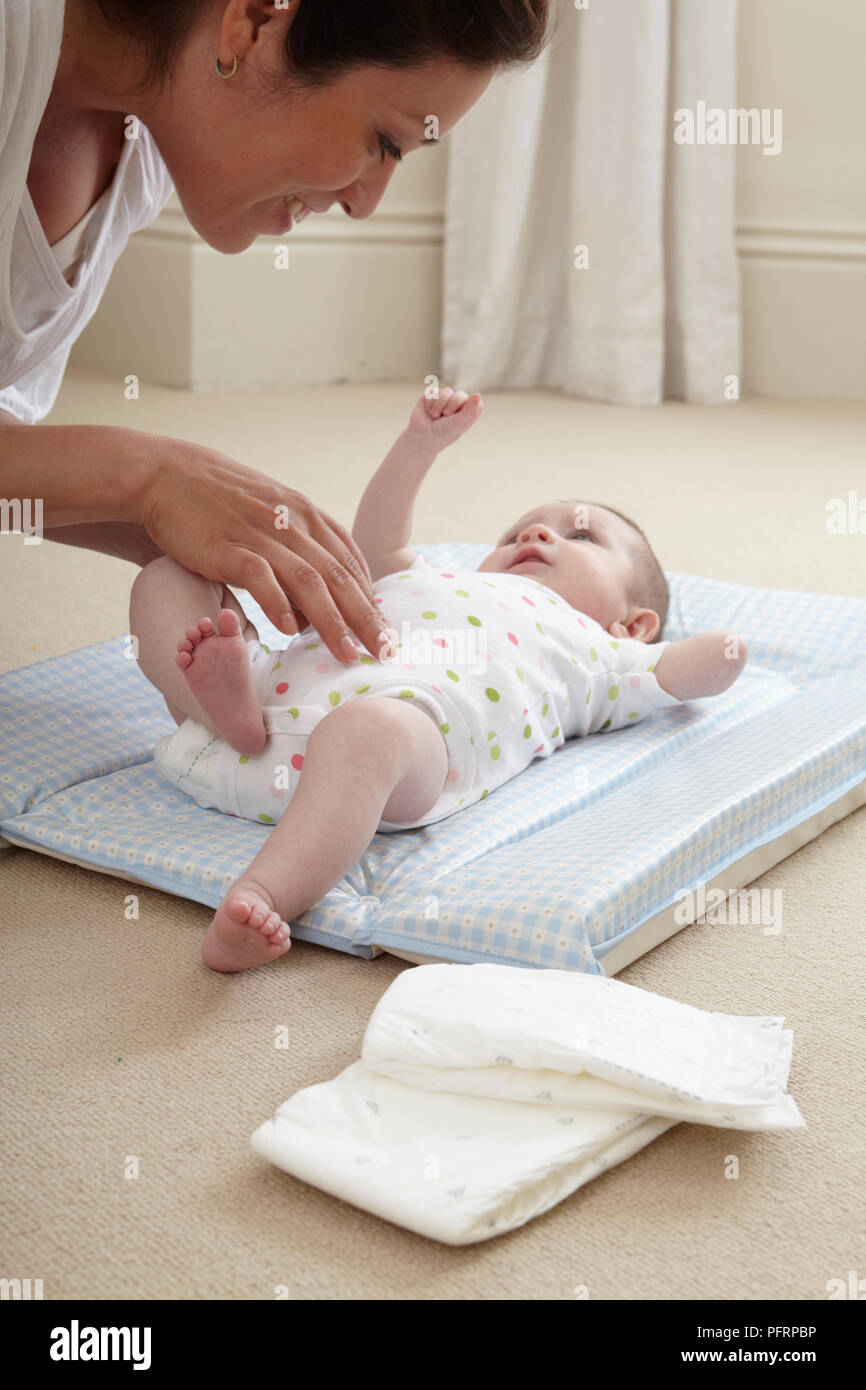 Baby Girl 3 Months On Nappy Changing Mat Woman Touching Her