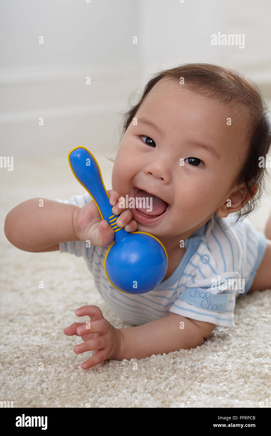 baby holding rattle