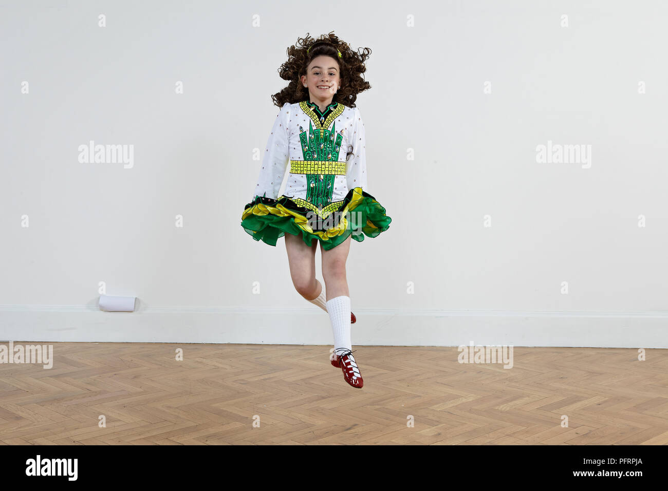 Girl performing jump (Irish dancing), front view Stock Photo Alamy