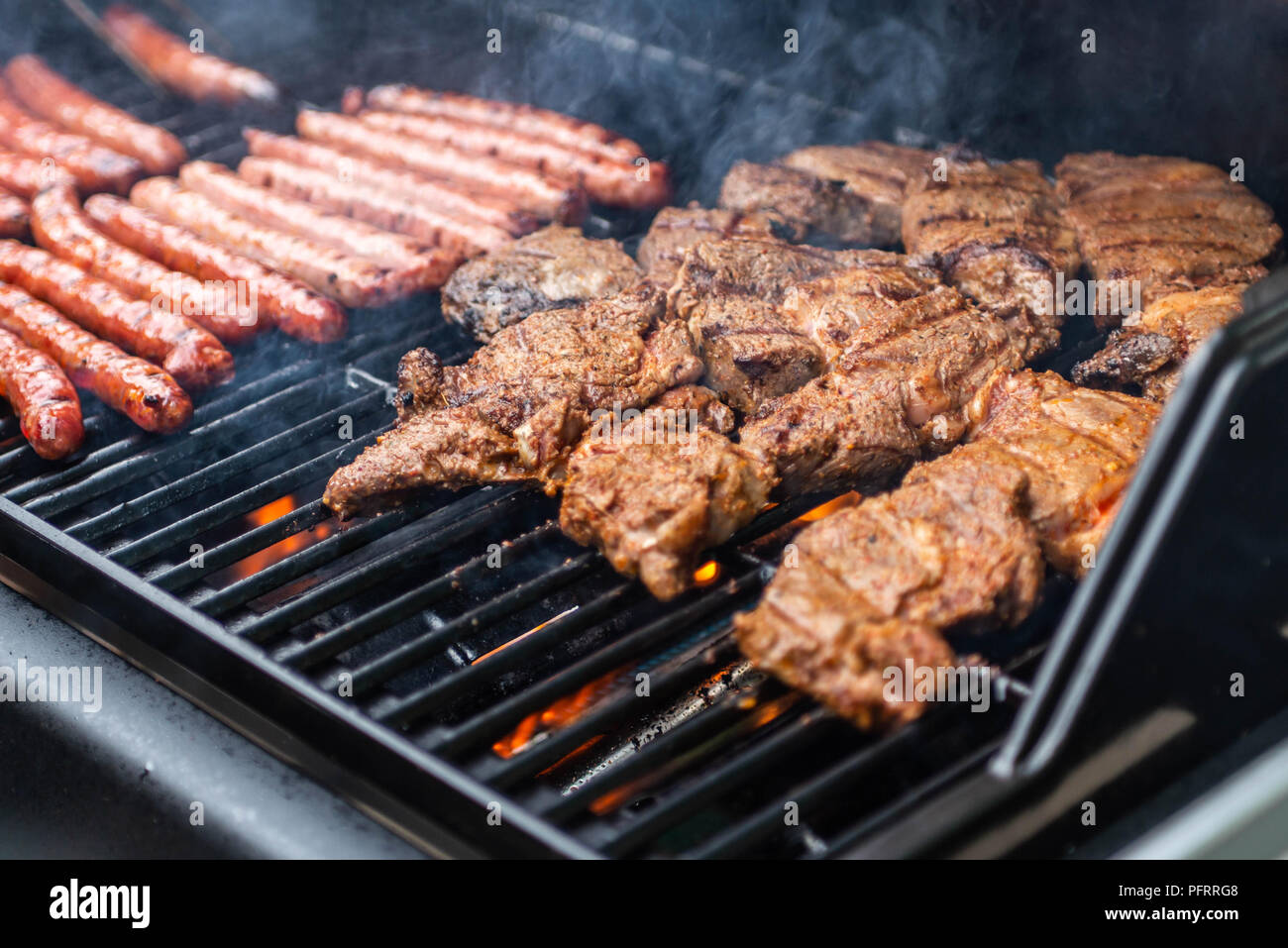 Barbecue grill bbq on propane gas grill. steaks bratwurst sausages meat
