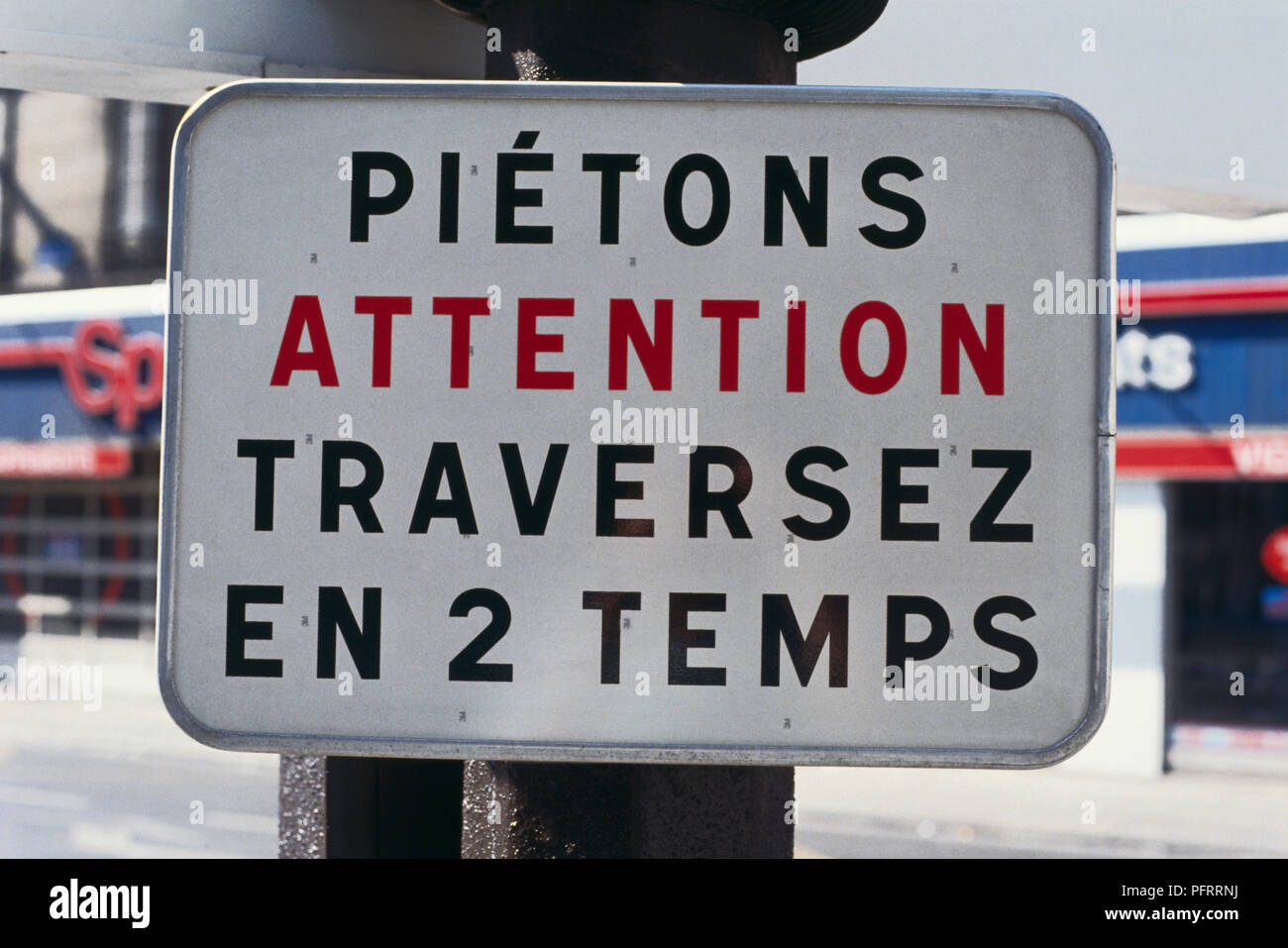 France, Paris, Attention sign in French and English for pedestrians to