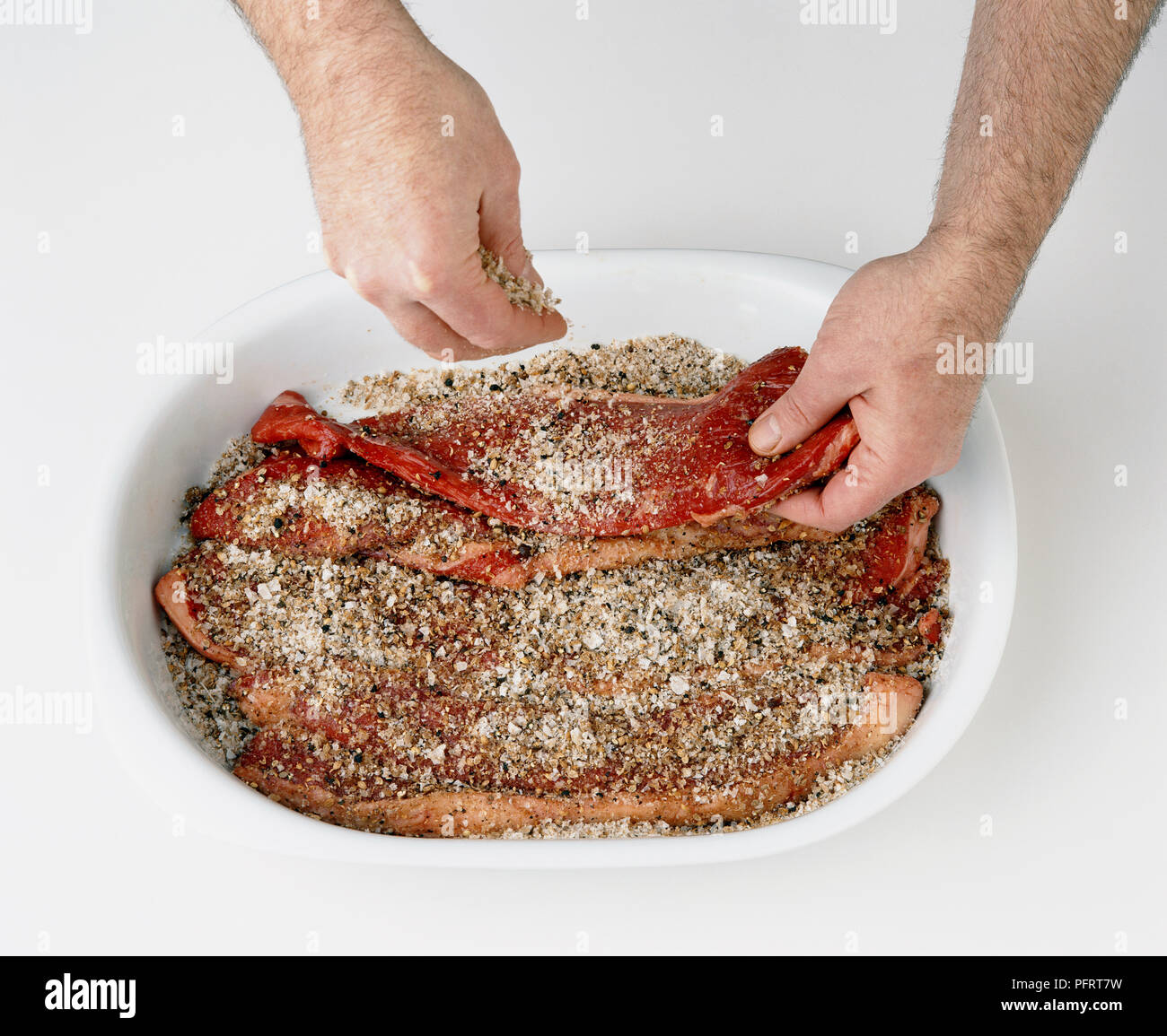 Strips of raw meat covered in spices (preparing biltong Stock Photo Alamy