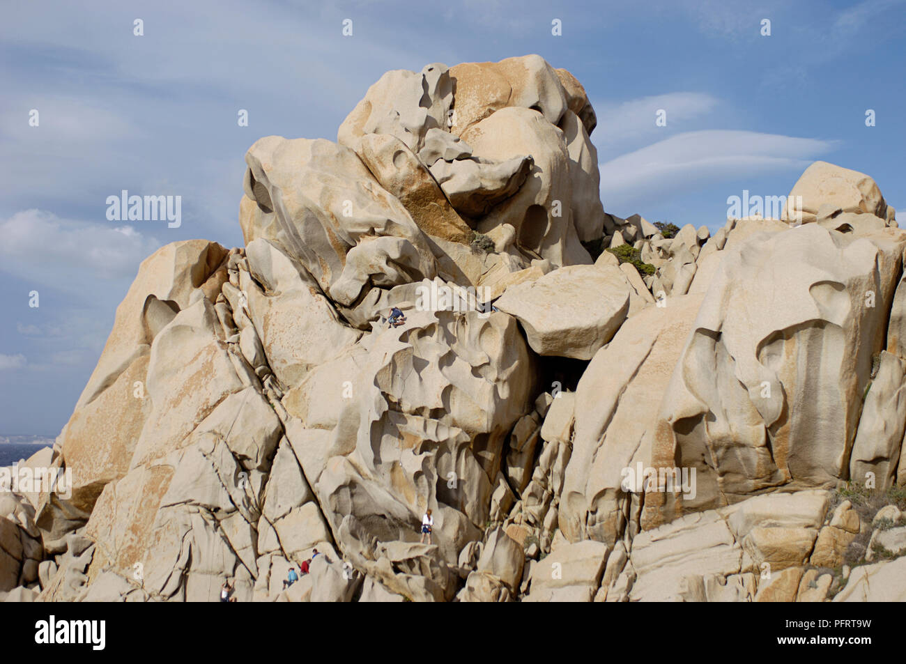 Italy, Sardinia, people climbing on granite crag Stock Photo