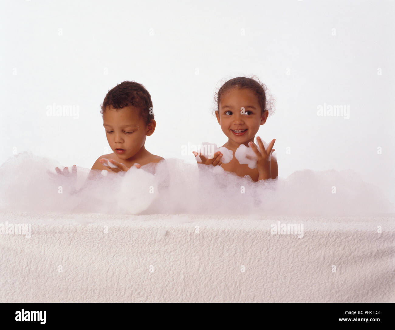 Girl and boy in bubble bath with bubbles on hands Stock Photo Alamy