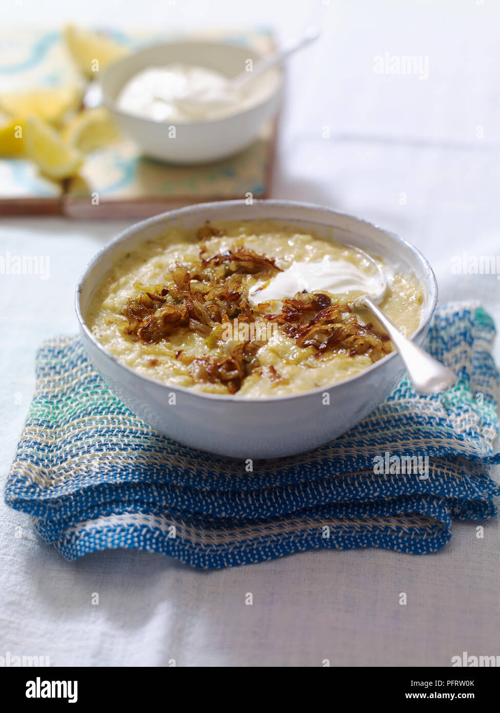 Chorba al-adas, thick lentil soup sprinkled with fried onions and dollop of yogurt Stock Photo