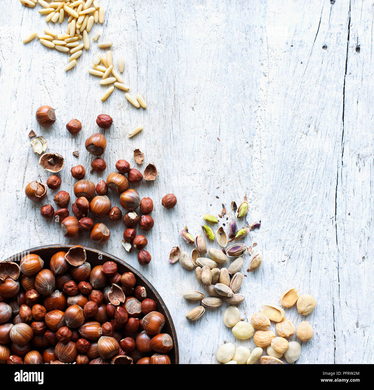 A selection of nuts on wood background Stock Photo