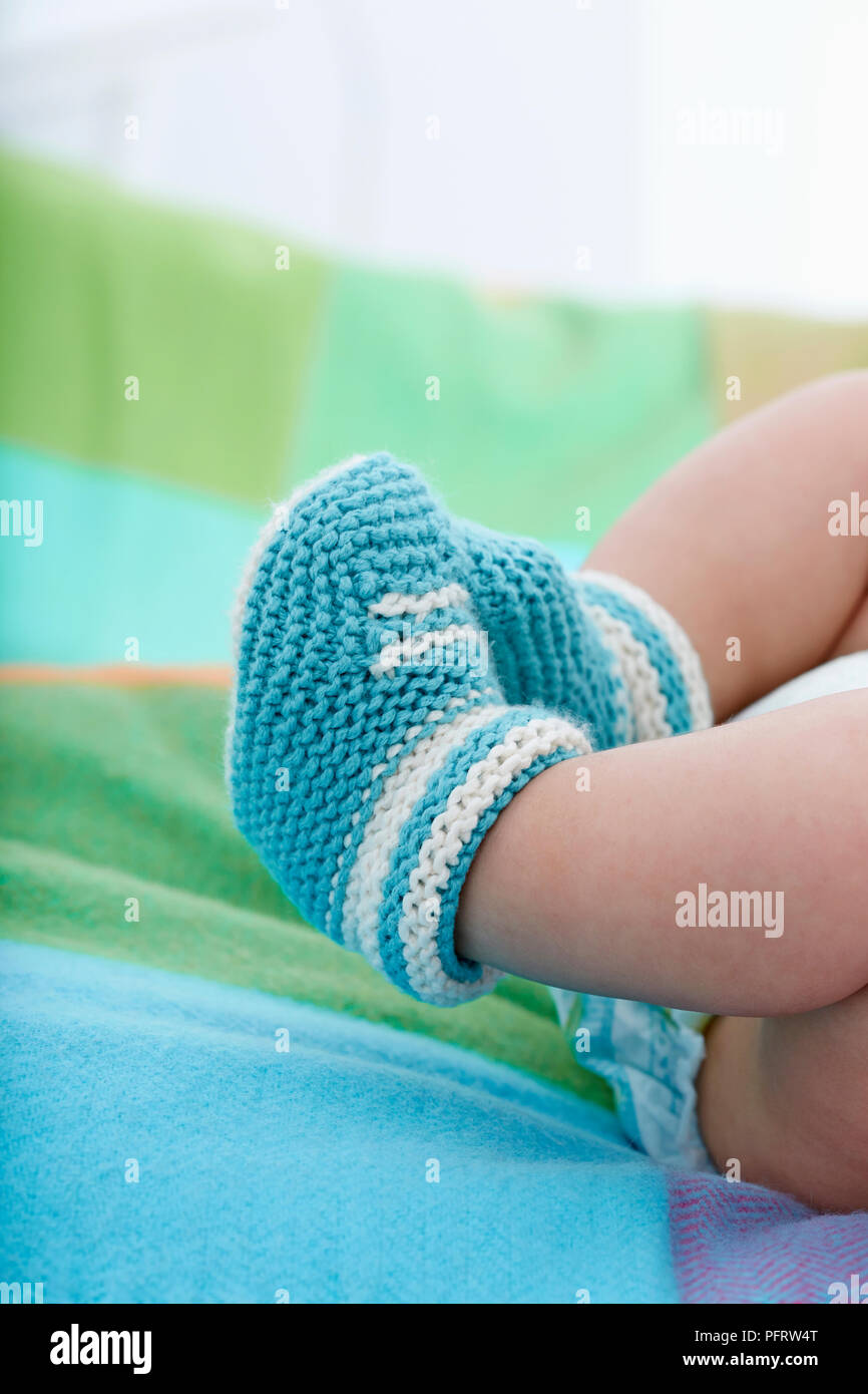 Baby wearing knitted baby booties Stock Photo Alamy