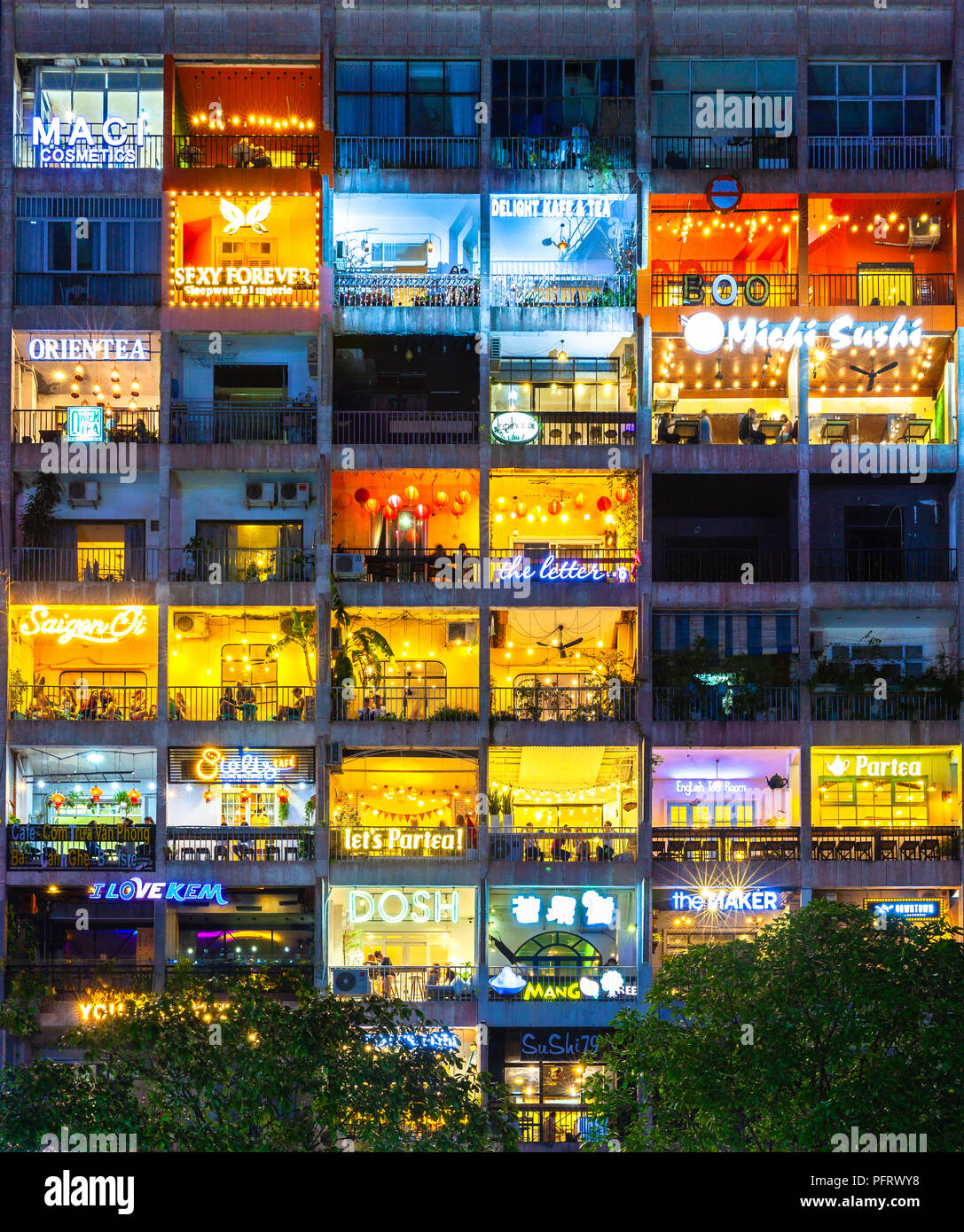 Ho Chi Minh City, Vietnam - August 17, 2018: People rest in cafes located in the old building The Cafe Apartment at the city center on August 17, 2018 Stock Photo