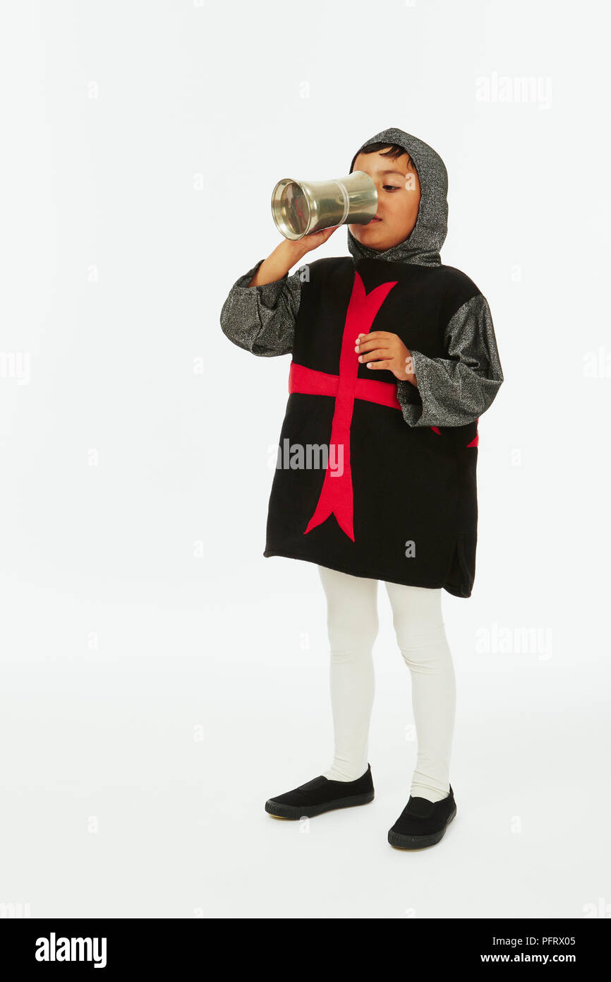 Young boy dressed in knight costume with wooden sword and shield Stock Photo