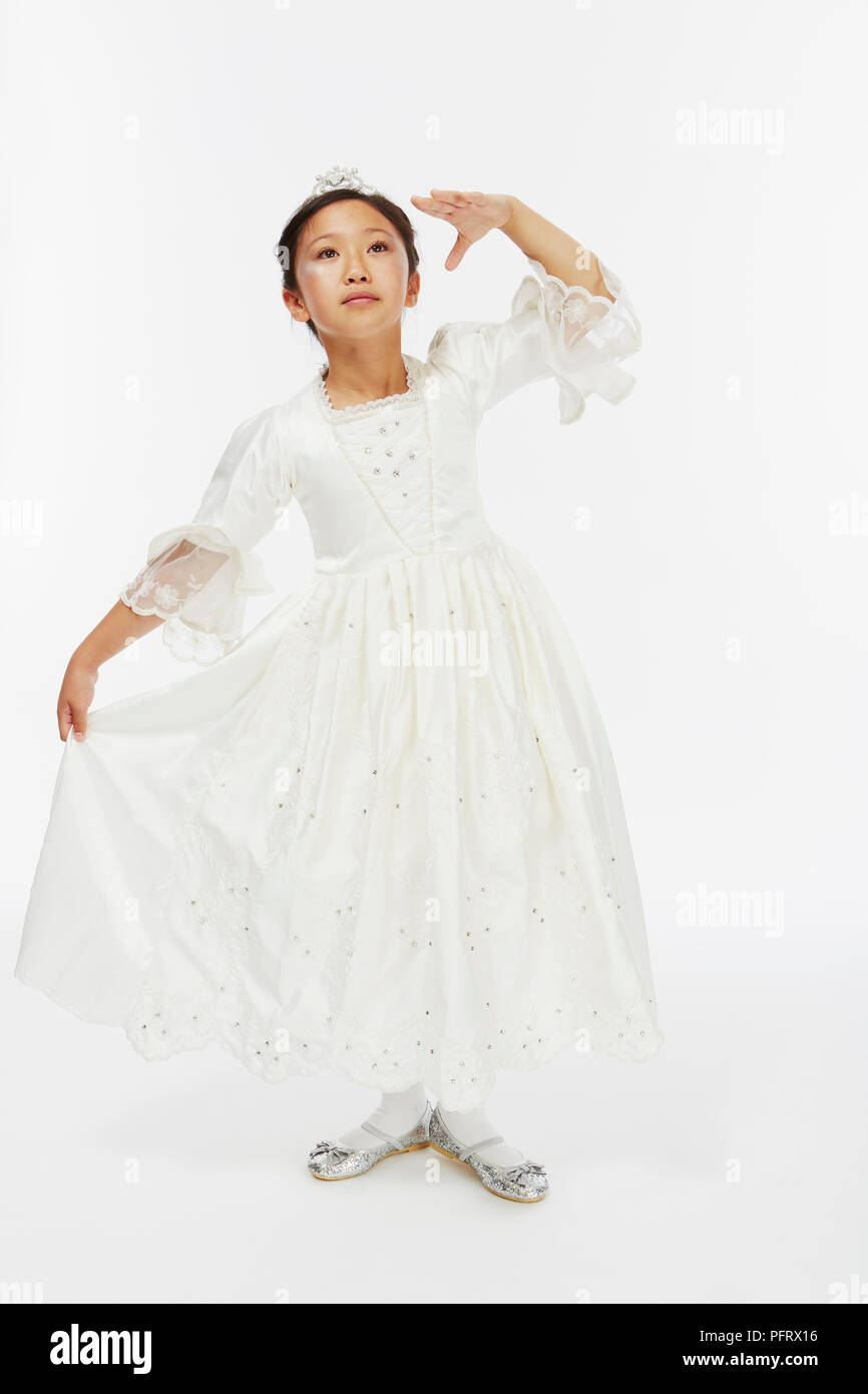 Young girl dressed as cinderella in white princess dress ball gown Stock Photo