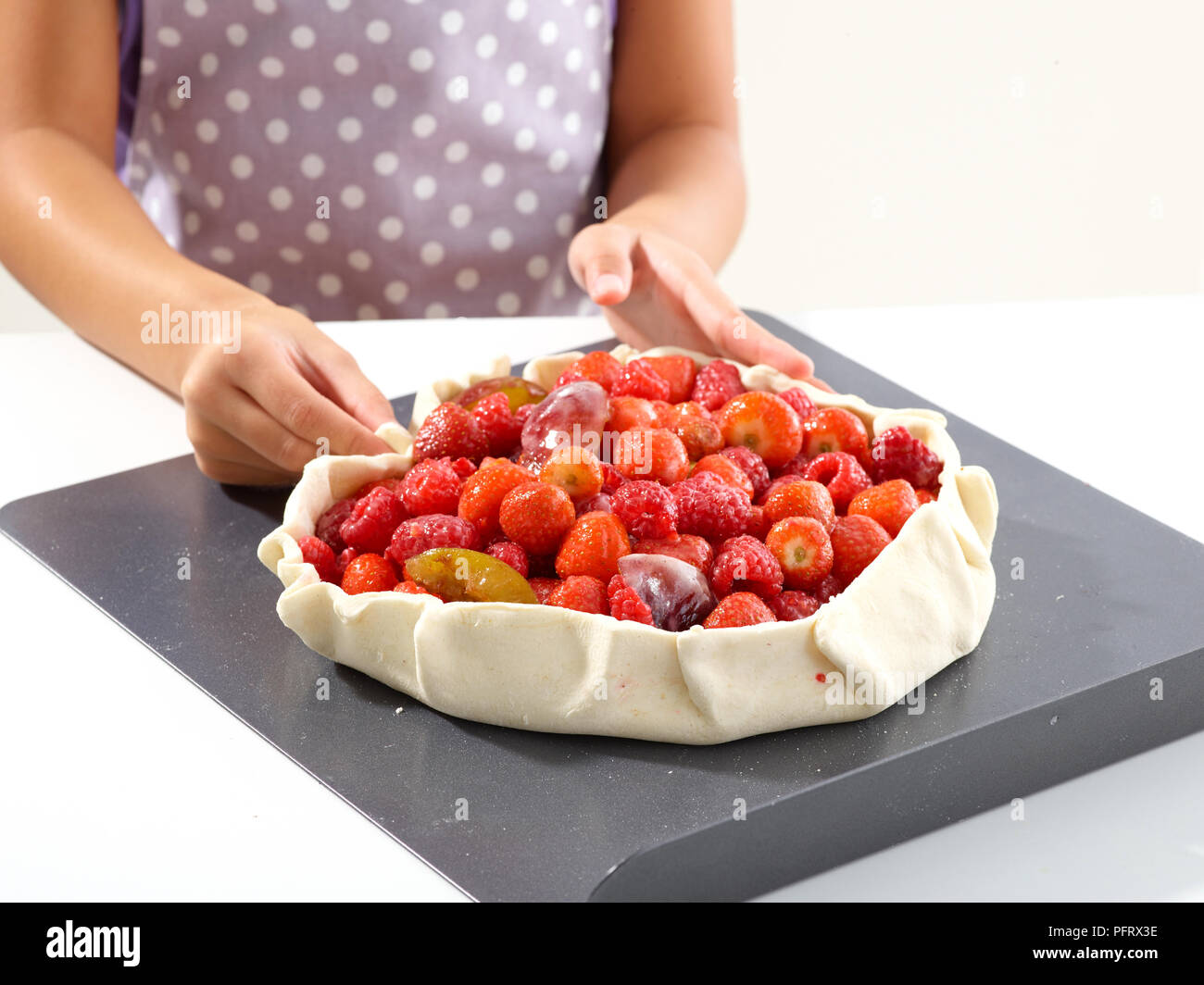 Berry and Plum Pie  Crimping the sides of the pastry (Step 5 of 6) Stock Photo