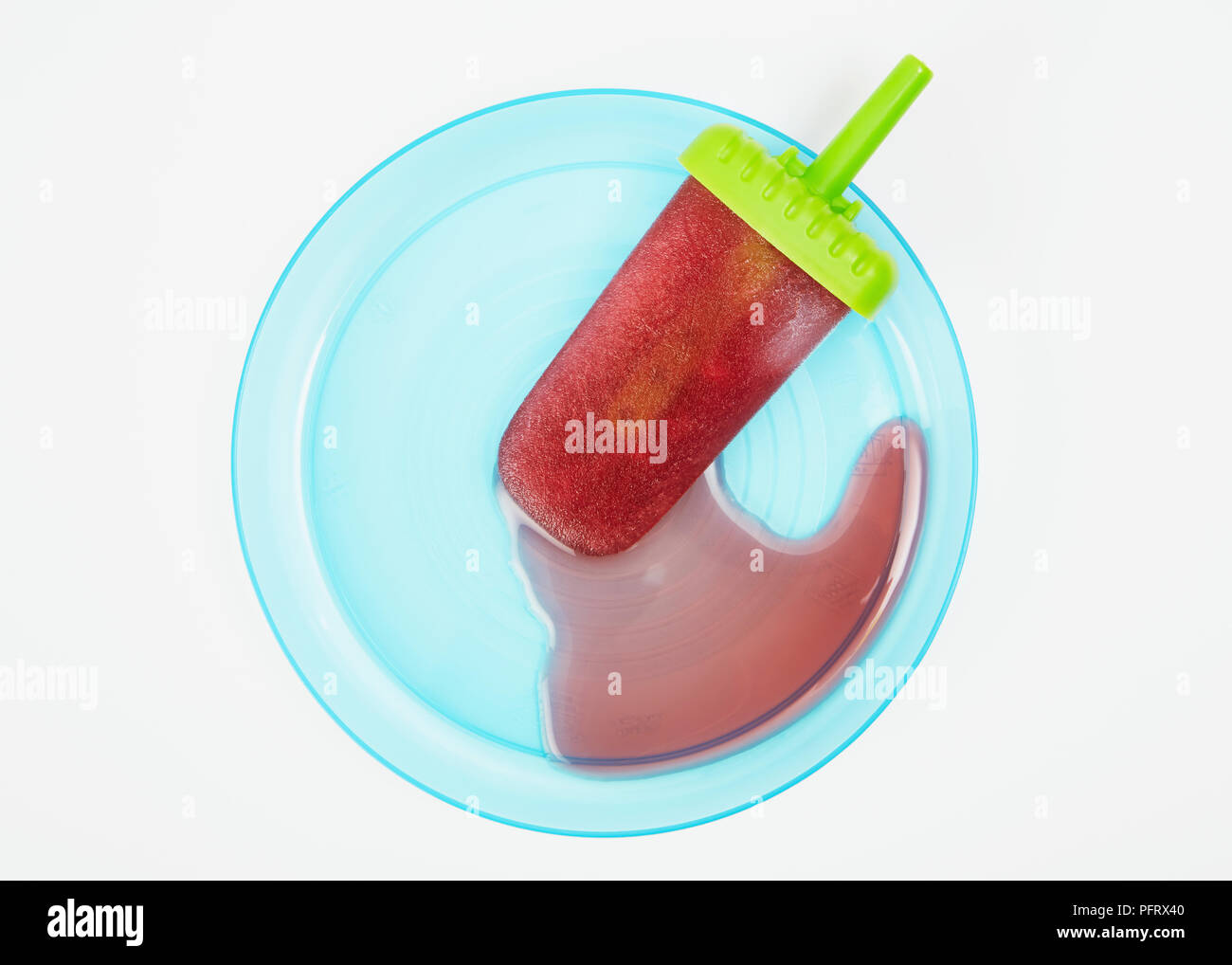 Ice lolly melting on a blue plate Stock Photo