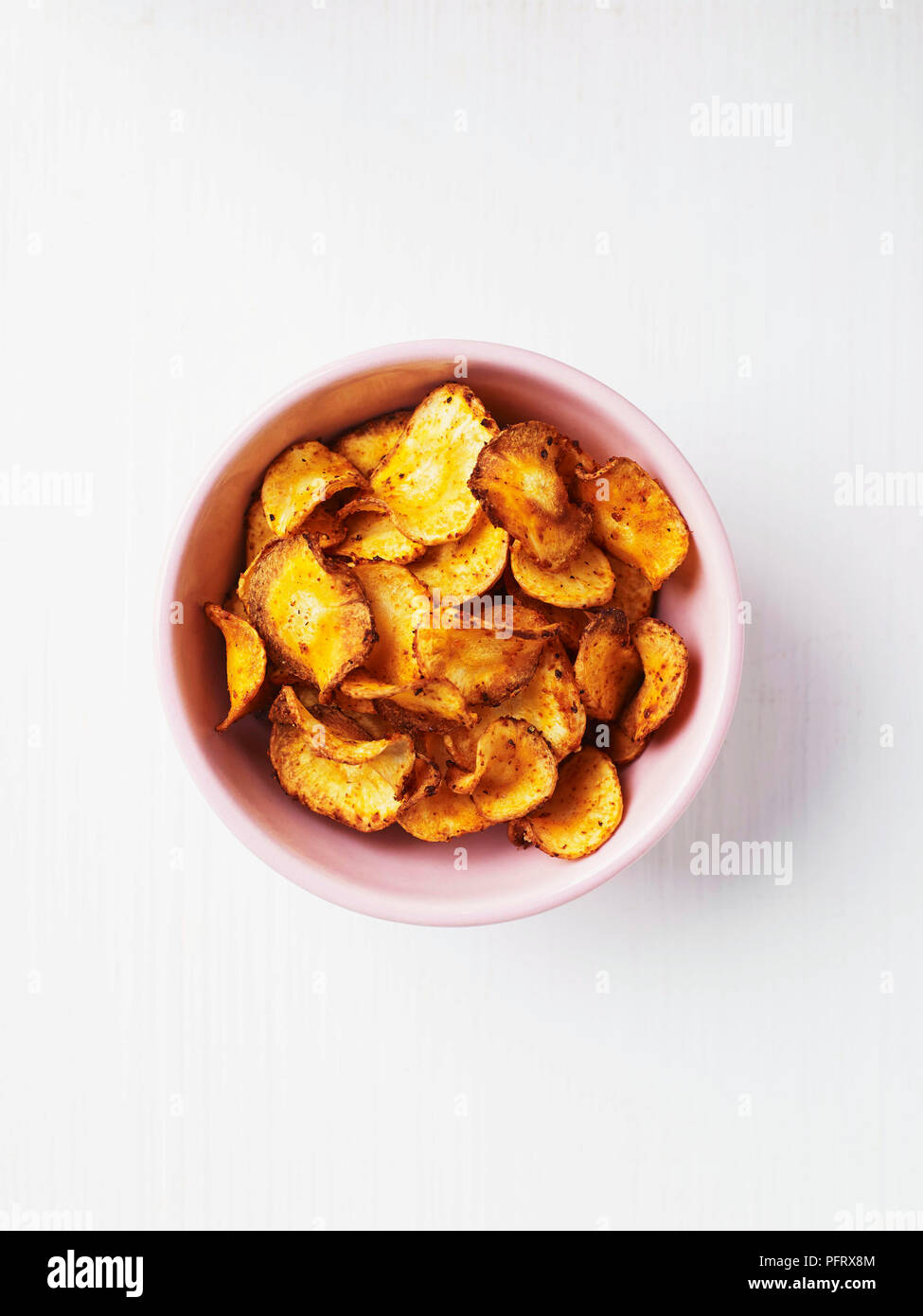 Parsnip vegetable crisps in a bowl Stock Photo