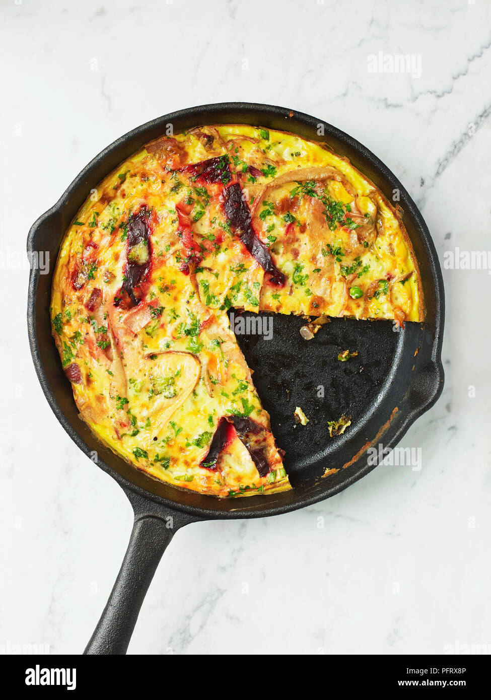 Vegetable frittata in a cast-iron pan Stock Photo
