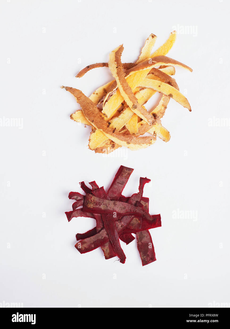 Piles of sweet potato and beetroot peel on a white background Stock Photo