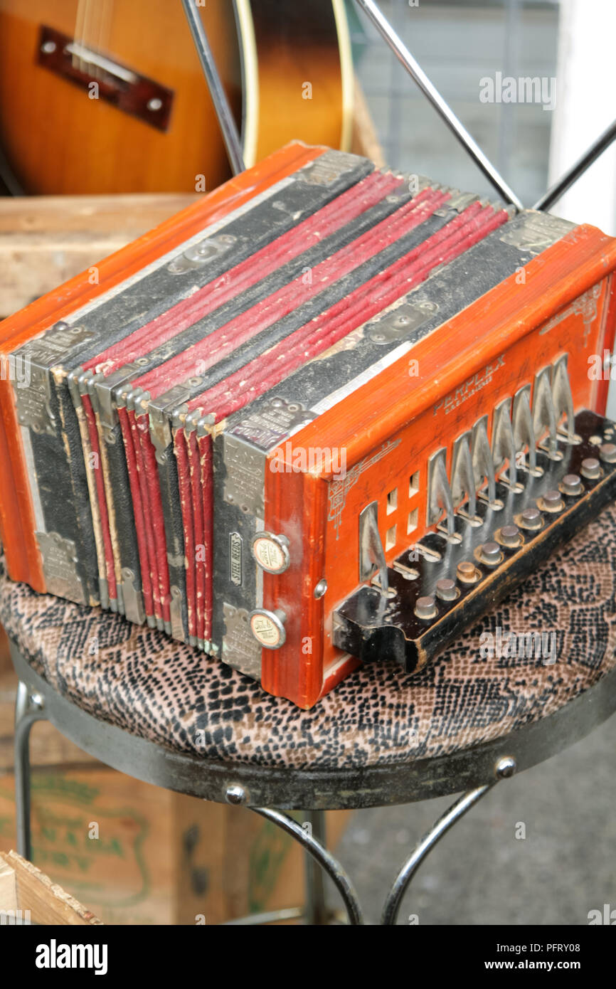 Tatty orange 'Tivoli' accordion on a flea market stall Stock Photo Alamy