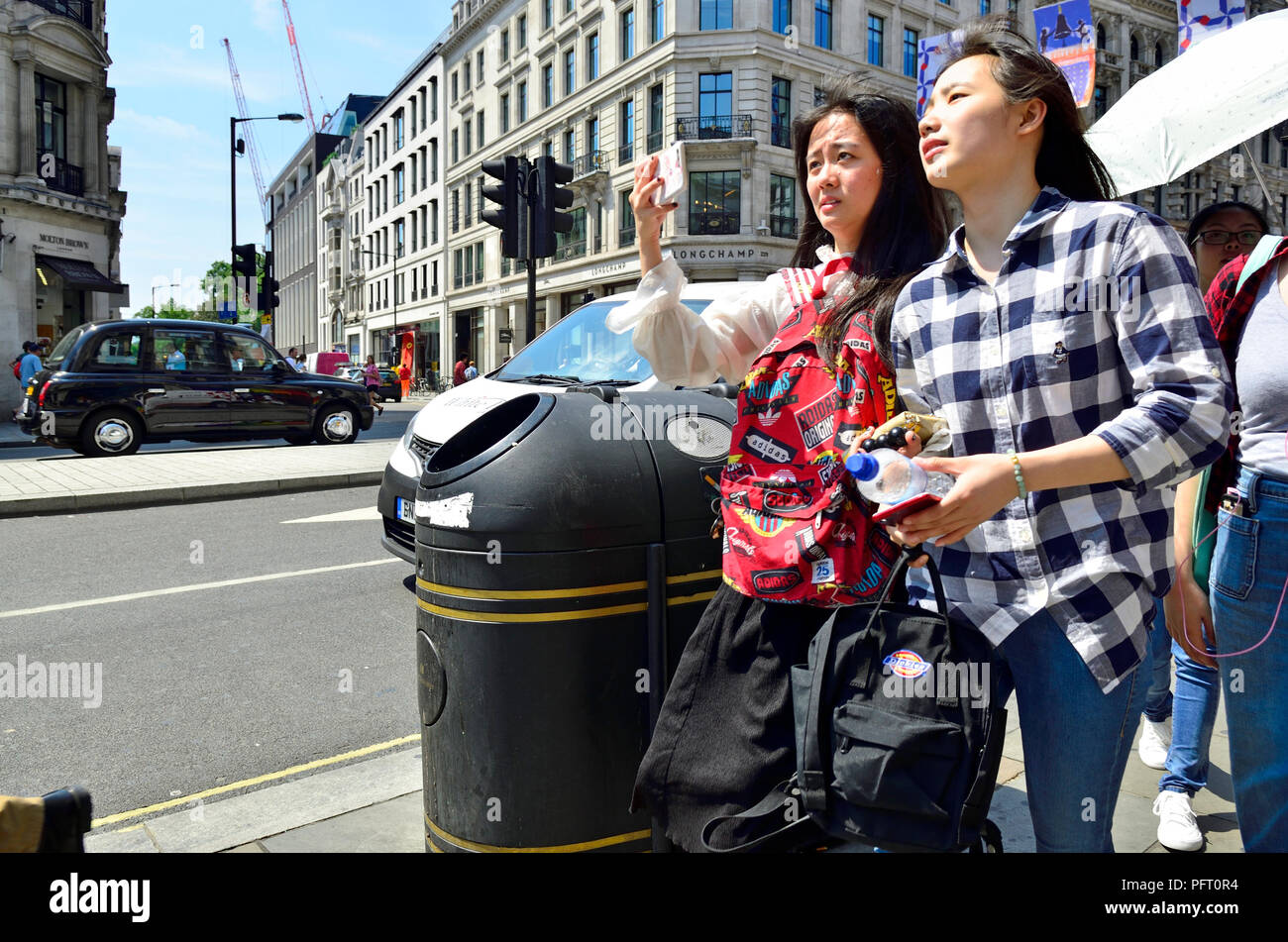 Asian tourists in Regent Street, London, England, UK. Stock Photo