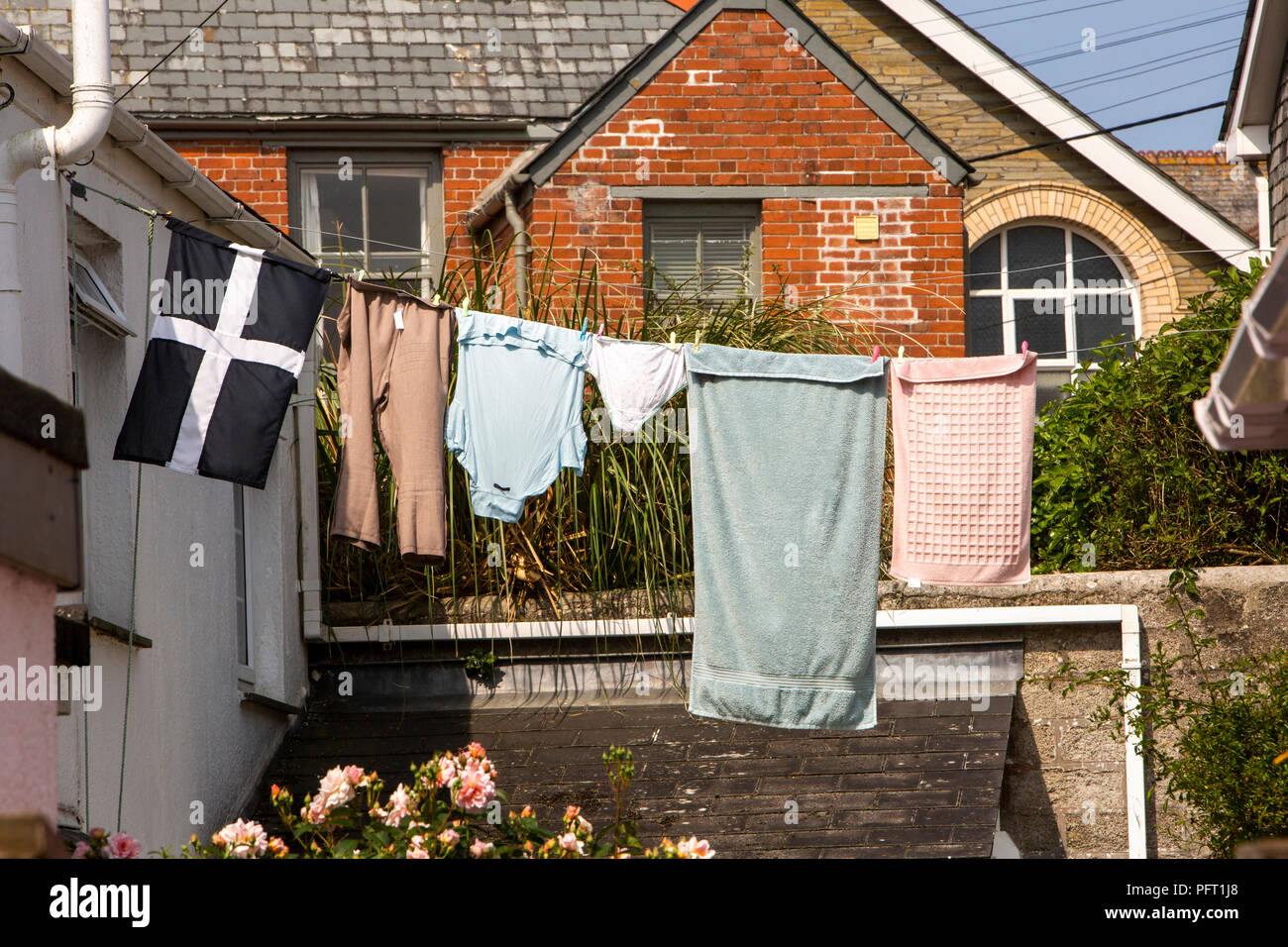 UK, Cornwall, Padstow, Middle Street, washing hanging on line including Cornish flag Stock Photo