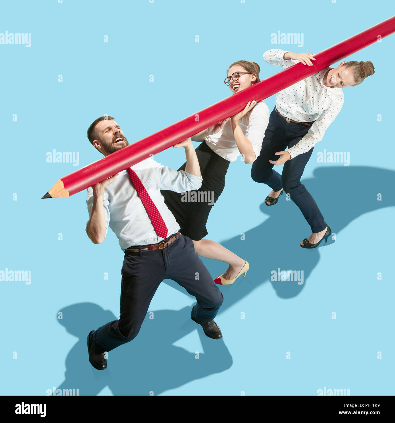 Teamwork and cooperation concept. Flat isometric view of man and women dragging a big pencil. Office items concept. Business processes, workplace concepts. Miniature people. Collage Stock Photo