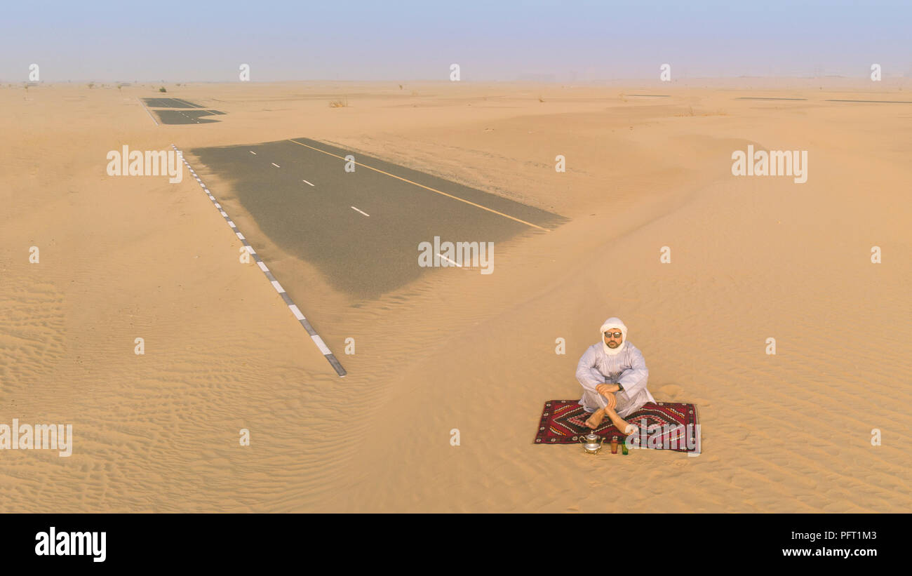 tuareg man drinking tea in a desert Stock Photo