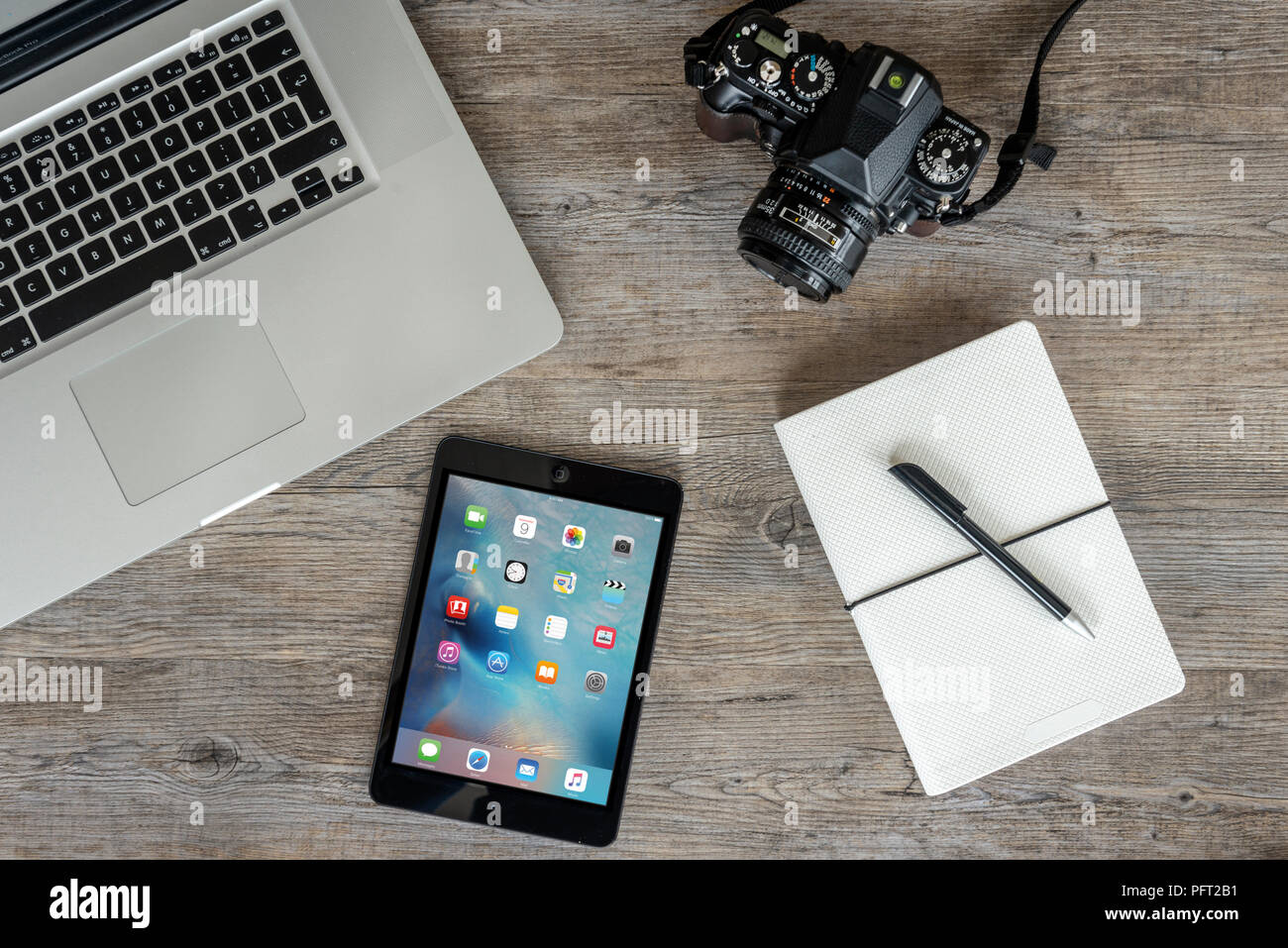 flat lay, wooden table top with laptop computer, retro camera and ipad. Stock Photo