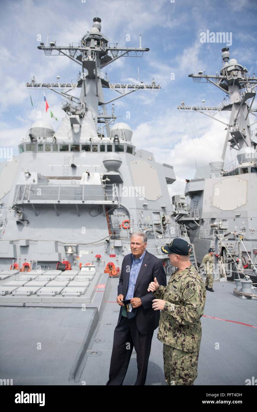 Everett, Wash. (May 31, 2018) Washington State Governor Jay Inslee tours the Arleigh Burke-class guided-missile destroyer USS Ralph Johnson (DDG 114) with Cmdr. Jason Patterson, Ralph Johnson's commanding officer. Ralph Johnson is the sixth and most recent destroyer to be home-ported in Naval Station Everett. Stock Photo