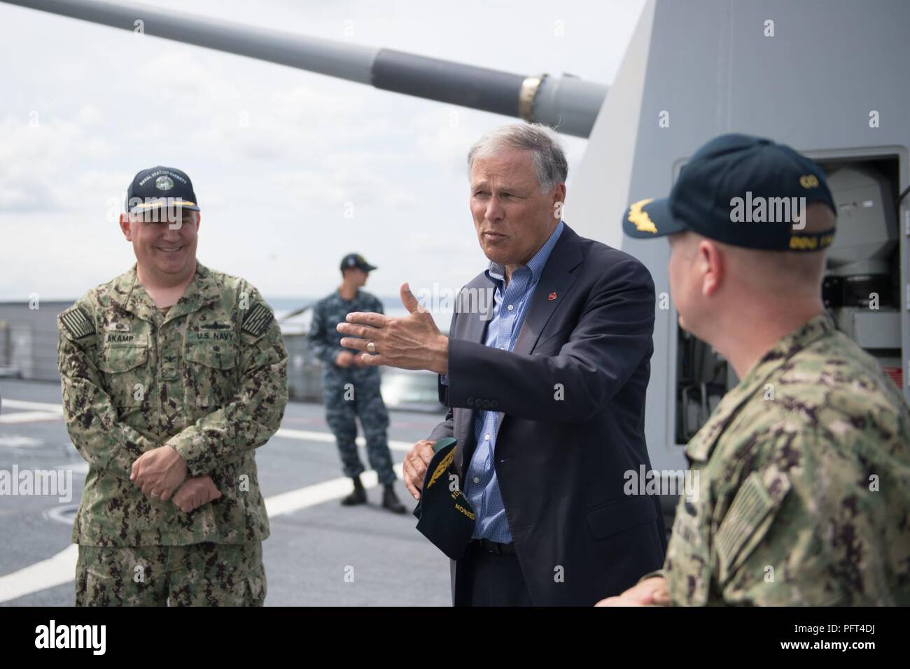 Everett, Wash. (May 31, 2018) Washington State Governor Jay Inslee tours the Arleigh Burke-class guided-missile destroyer USS Ralph Johnson (DDG 114) with Capt. Mark Lakamp, commanding officer, Naval Station Everett (NSE), and Cmdr. Jason Patterson, Ralph Johnson's commanding officer. Ralph Johnson is the sixth and most recent destroyer to be home-ported at NSE. Stock Photo