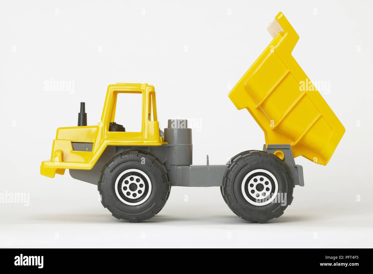 Yellow and grey plastic toy dumper truck Stock Photo Alamy