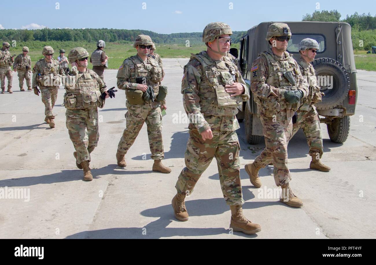 Yavoriv, Ukraine – Maj. Gen. Raymond Shields, commander of the New York Army National Guard, meets with 27th Infantry Brigade Combat Team Soldiers during a visit to the Yavoriv Combat Training Center here May 25. During his visit Shields toured the CTC and awarded challenge coins to U.S. service members to recognize them for their hard work. Stock Photo