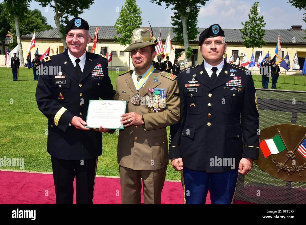 Brig. Gen. Eugene J. LeBoeuf, the U.S. Army Africa acting commanding general (left) and Command Sgt. Maj. Jeremiah E. Inman, U.S. Army Africa command sergeant major (right) , present the Distinguished Service Medal to the outgoing Italian Base Command Sgt. Maj. Antonio Quaglia during the Italian Base Command Change of Responsibility at Caserma Ederle in Vicenza, Italy, May 31, 2018. Stock Photo