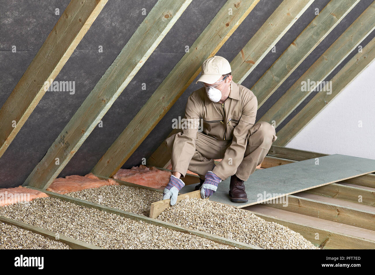 Man Wearing Overalls Mask Gloves And Cap Levelling Loose
