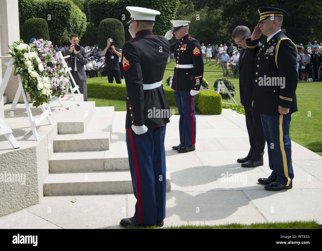 U.S. military and Steven Vandeput, center right, Belgian Minister of Defense, pay respects after laying a wreath in honor of the fallen during a Memorial Day ceremony at Flanders Field American Cemetery, Belgium, May 27, 2018. Military and civilian representatives attended the ceremony, including Brig. Gen. Dieter E. Bareihs, Headquarters U.S. Air Forces in Europe and Africa director of plans, programs and analyses, and a representative of the King of Belgium. Stock Photo