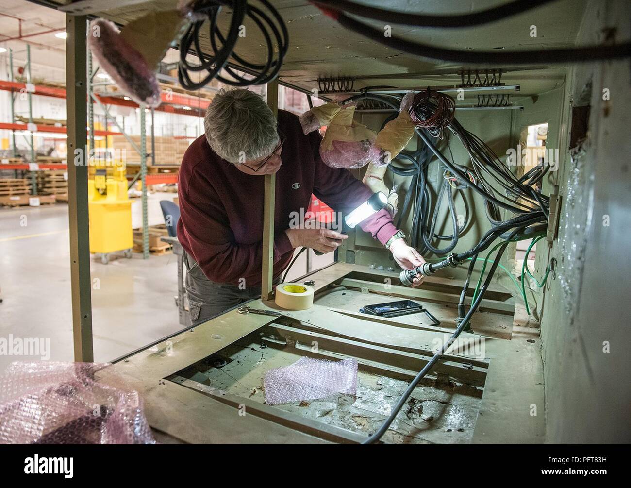 Brian Brogan, electronic integrated systems mechanic, repairs cables and connectors on an AN/TSC