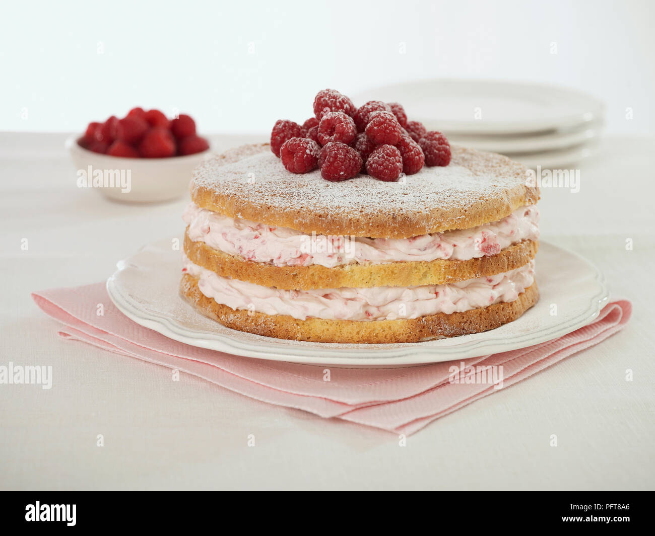 Genoise cake on plate on top of folded pink napkin Stock Photo - Alamy