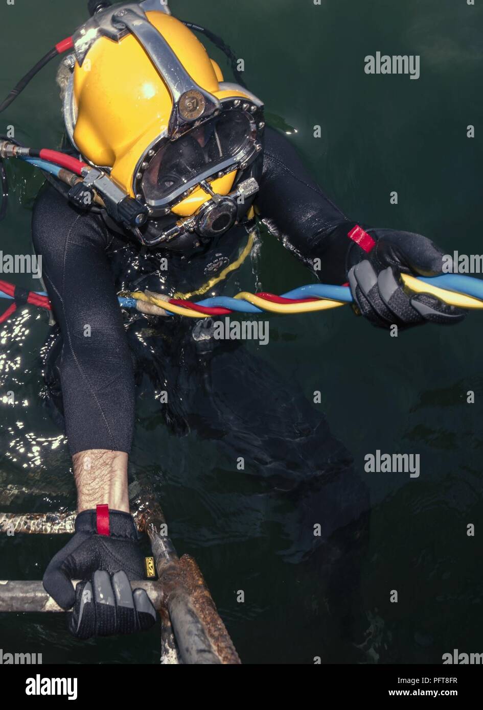 U.S. Army Sgt. Eoin Audet, assigned to 7th Engineer Dive Detachment, 84th Engineer Battalion, 130th Engineer Brigade, prepares to complete a dive during an underwater recovery operation off the coast of Hoang Mai, Vietnam, May 24, 2018. The recovery effort was conducted by the Defense POW/MIA Accounting Agency (DPAA) to locate service members who went missing during the Vietnam War. DPAA conducts global search, recovery and laboratory operations to provide the fullest possible accounting for our missing personnel to their families and the nation. Stock Photo