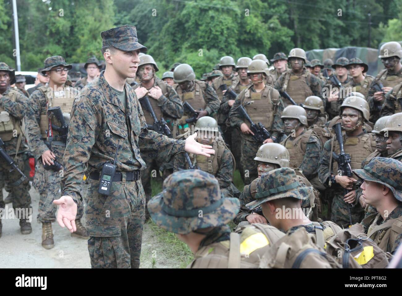 U.S. Marine Corps Sgt. Jesse M. Palmieri, an instructor assigned to Field Medical Training Battalion-East, gives a safety brief to U.S. Navy Sailors and Marines during the final exercise (FINEX) at Camp Johnson, N.C., May 29, 2018. FINEX is a culminating event which transitions Sailors into the Fleet Marine Force. Stock Photo