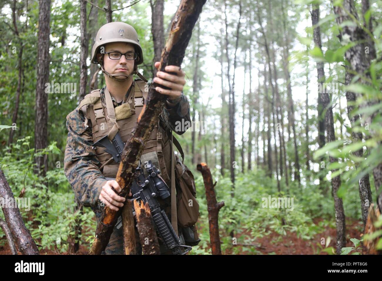 U.S. Navy Seaman Evan W. Power, a corpsman attending Field Medical Training Battalion-East, fortifies his position during a final exercise (FINEX) at Camp Johnson, N.C., May 29, 2018. FINEX is a culminating event which transitions Sailors into the Fleet Marine Force. Stock Photo