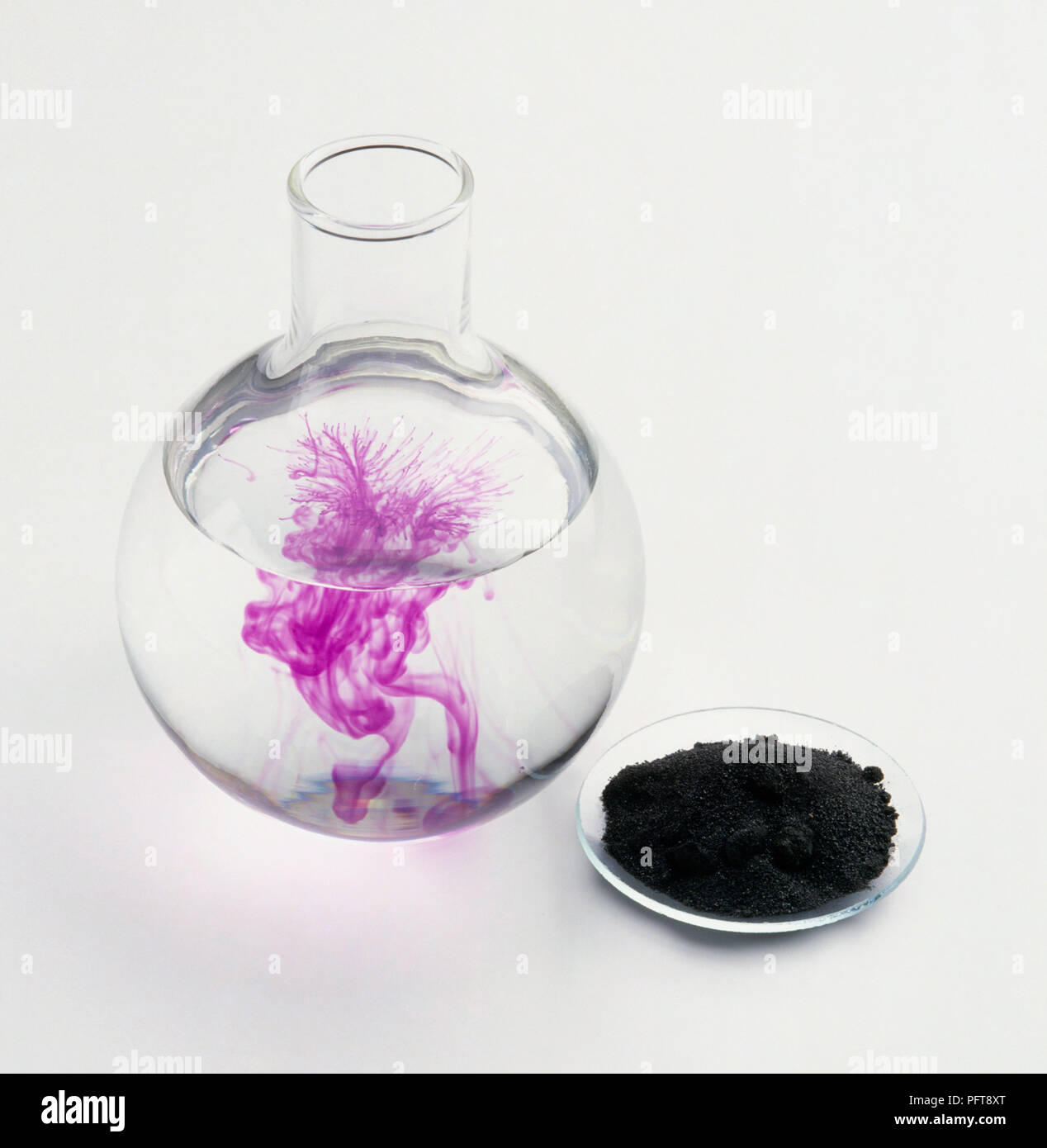 Potassium permanganate crystals dissolving in water Stock Photo Alamy