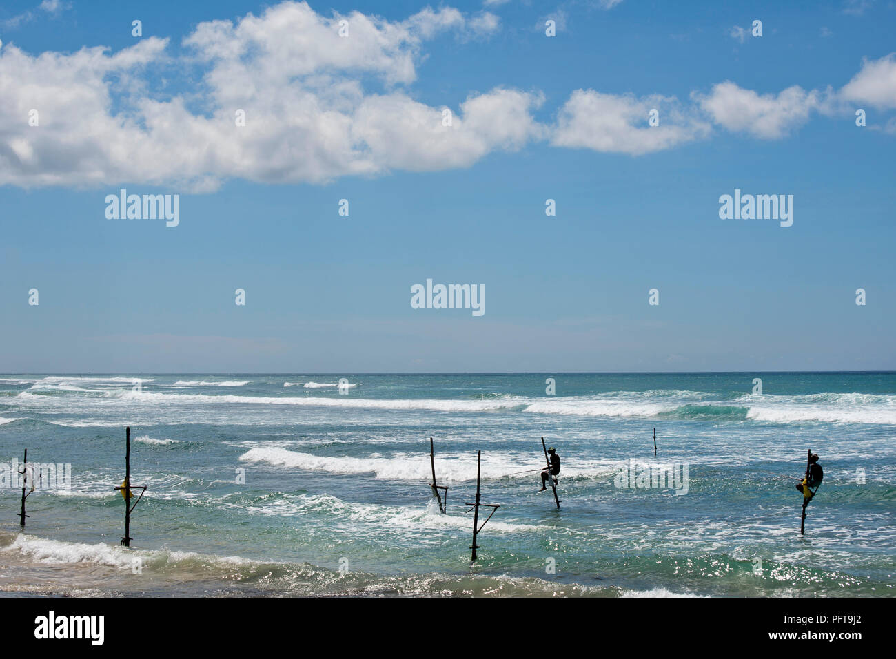Sri Lanka, Southern Province, Midigama, stilt fishermen fishing in sea Stock Photo