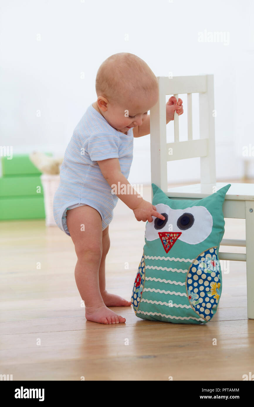 baby holding cushion