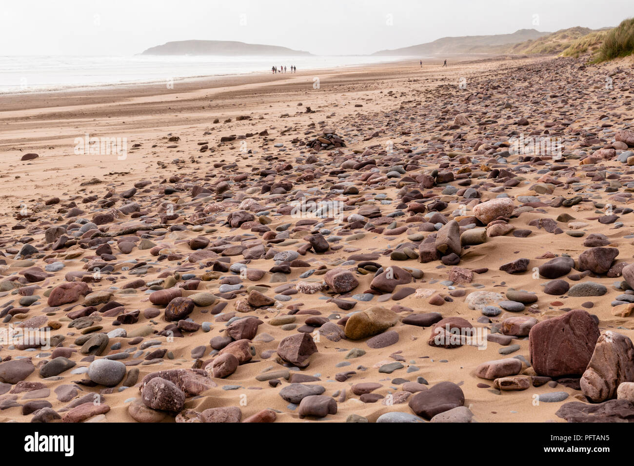 People on Rhossili beach on a windy day on the South Wales coast Stock Photo