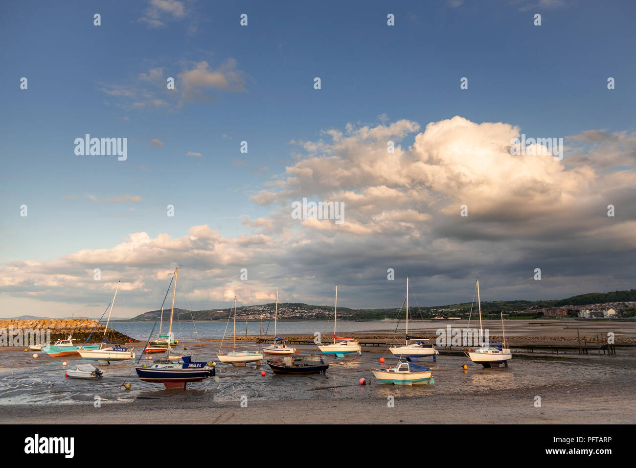 Small boats at low tide in Rhos-on-Sea harbour on the North Wales coast Stock Photo