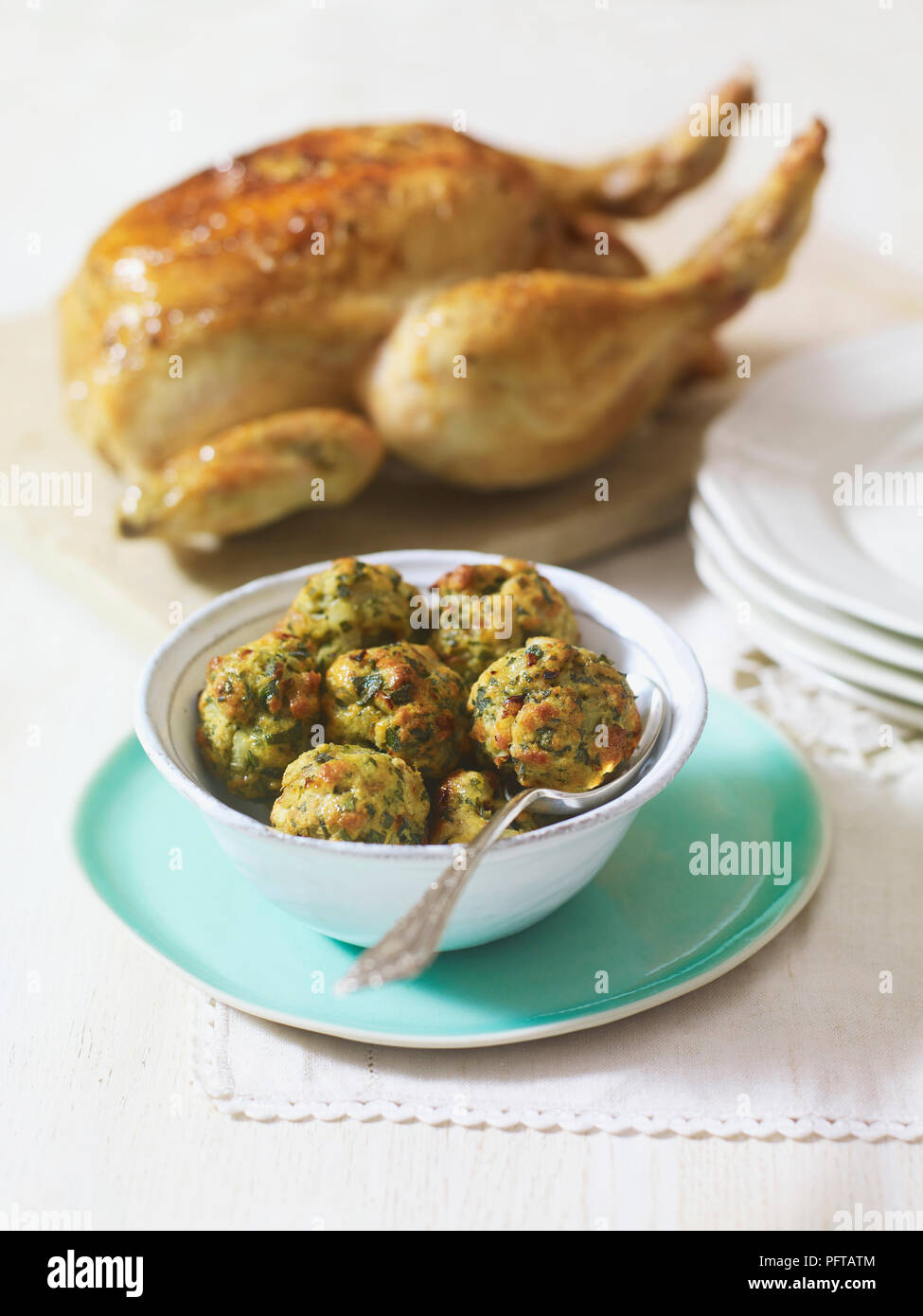 Bowl of stuffing balls and roast chicken Stock Photo
