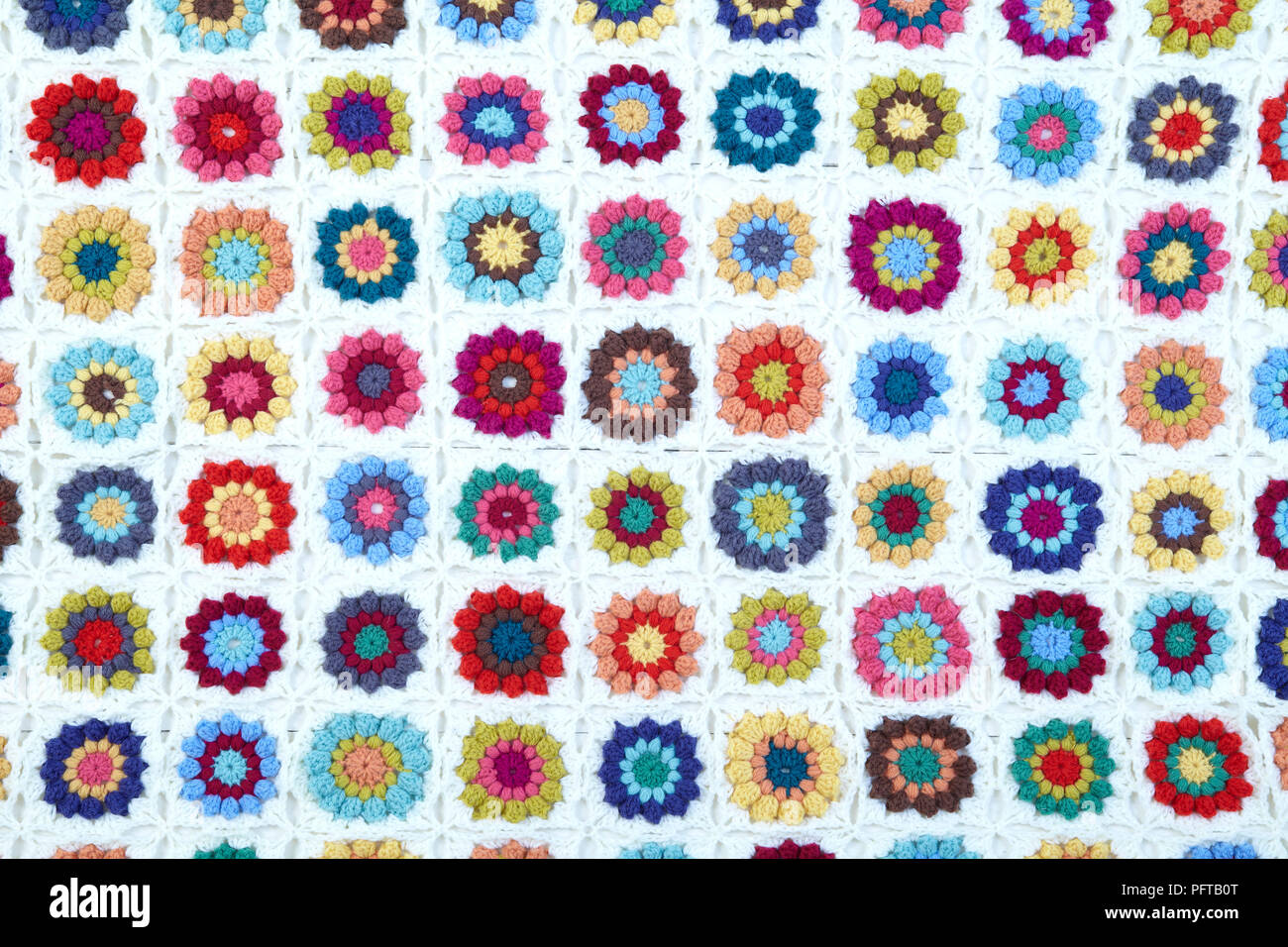 Crocheted granny square blanket with flowers Stock Photo