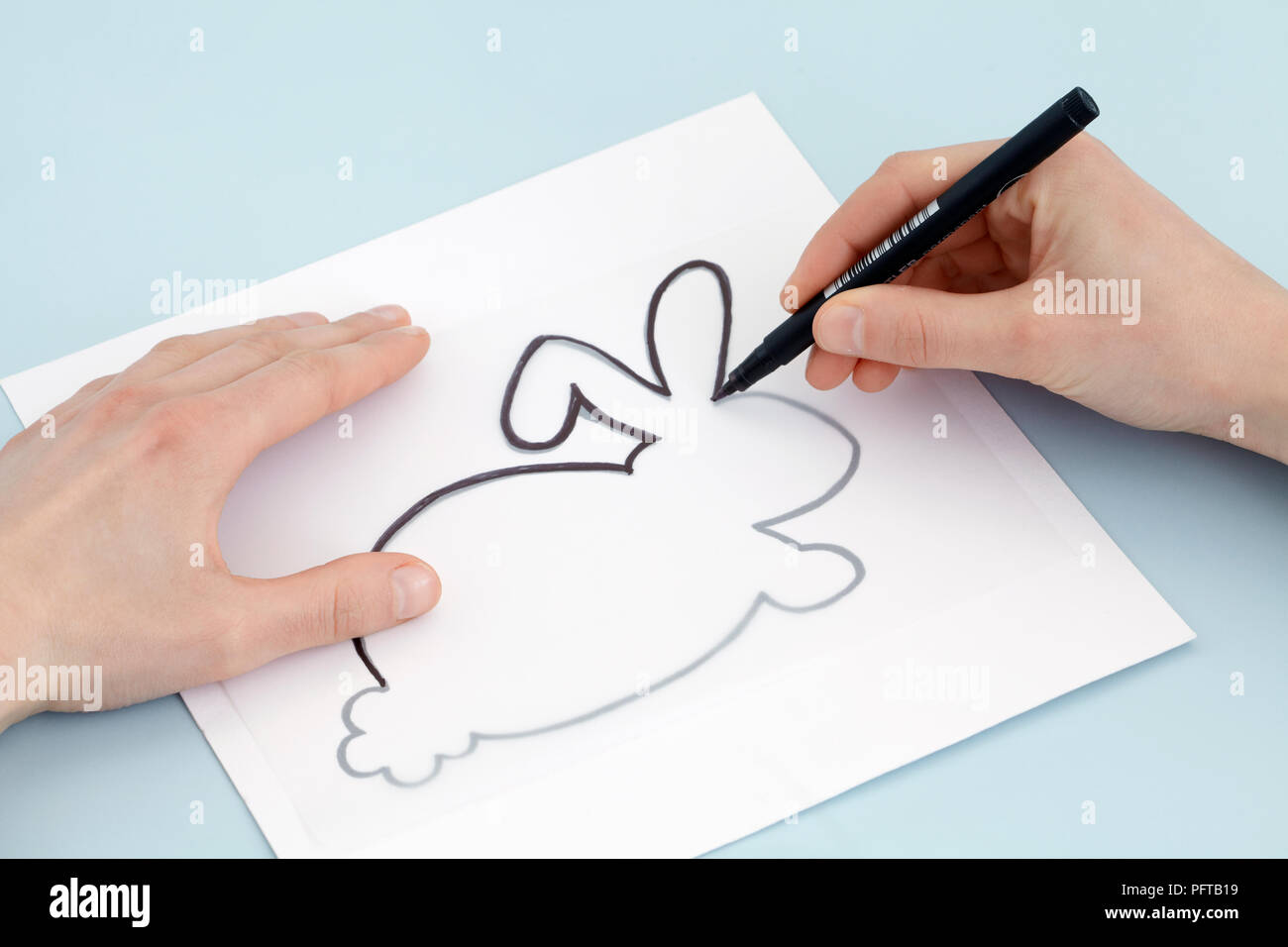 Drawing rabbit design on tracing paper Stock Photo