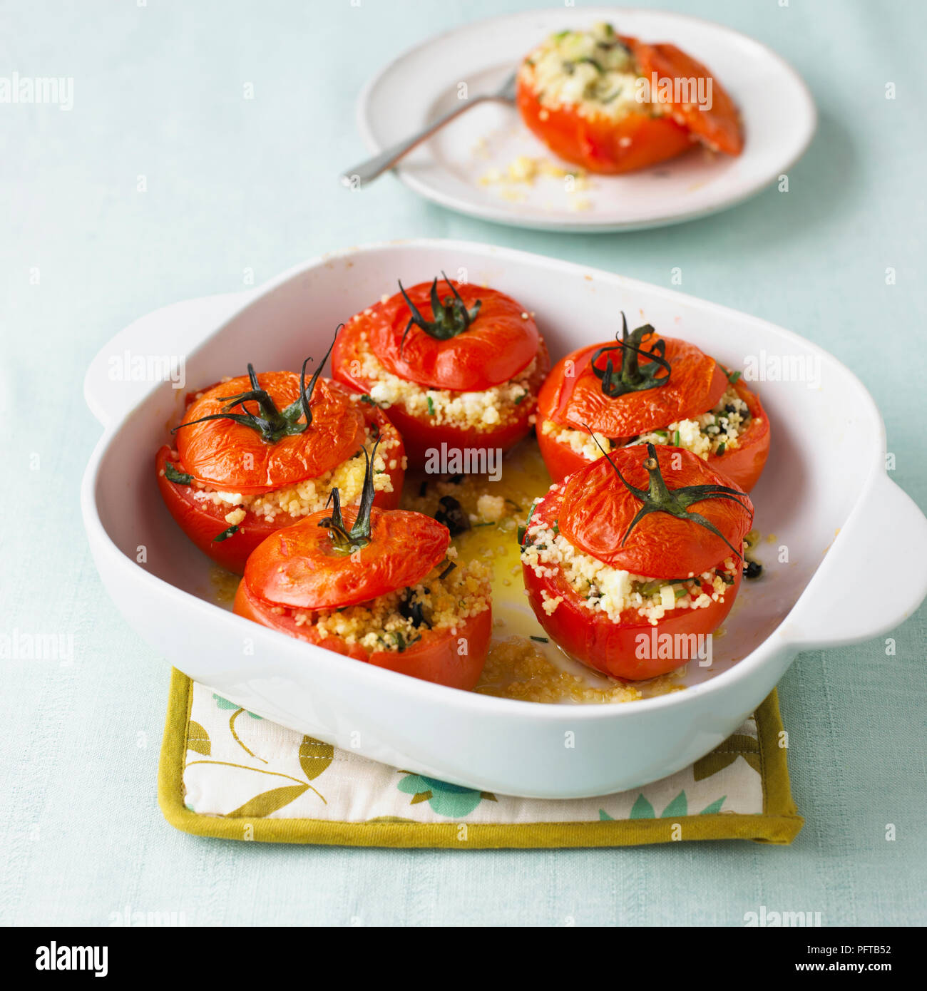 Baked tomatoes stuffed with couscous Stock Photo