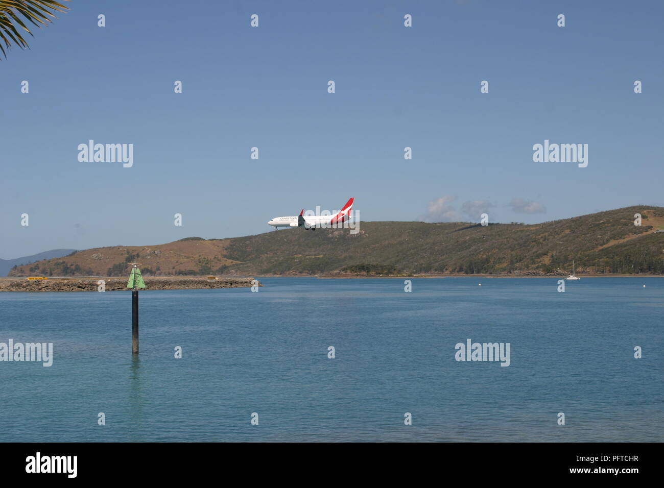 Qantas plane lines up for landing on Hamilton Island, Whitsunday Coast, Queensland, Australia. Stock Photo
