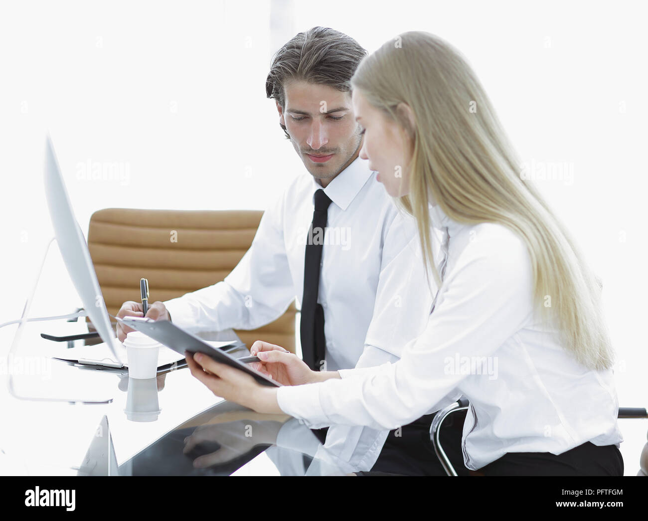 Manager and employee discussing working papers Stock Photo