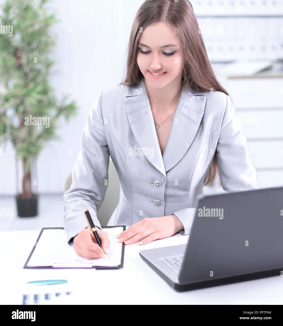 woman assistant making a record on a sheet of paper Stock Photo - Alamy