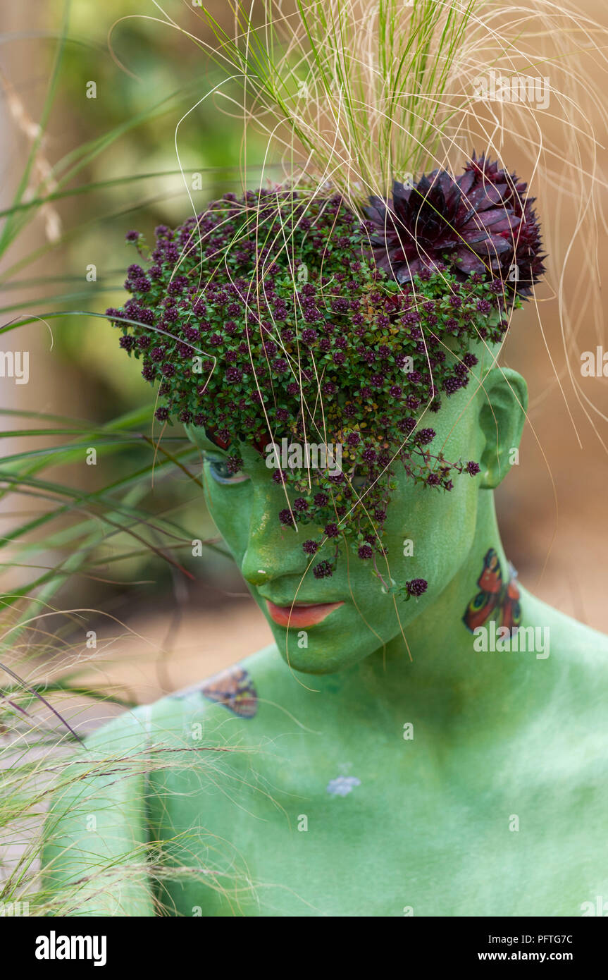 Head of female mannequin with plants growing out of the top Stock Photo